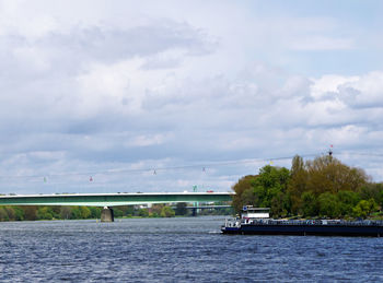 Scenic view of river against cloudy sky