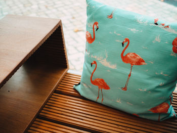 Close-up of flamingoes printed on cushion