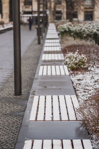 Bench on footpath in city