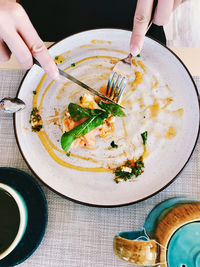 High angle view of person preparing food on table