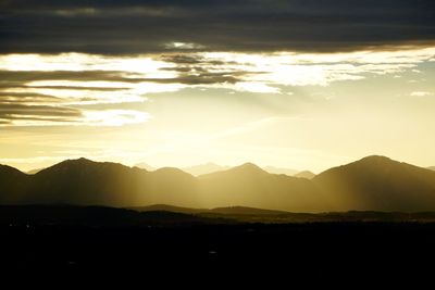 Scenic view of mountains against sky at sunset