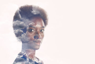 Close-up portrait of serious young woman over white background