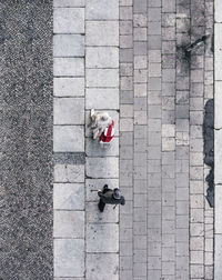 High angle view of people walking on footpath in city