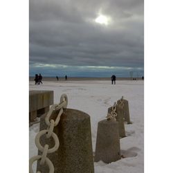 People on beach against sky