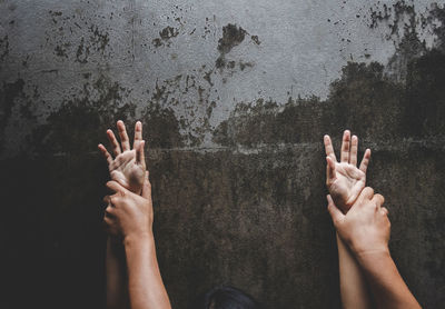 Cropped image of couple doing sex against wall at home