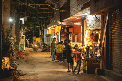 People walking on street at night