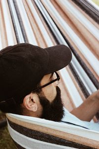 Close-up of man resting in hammock