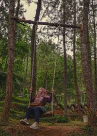 Man by trees in forest