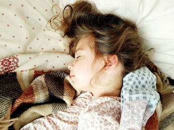 High angle view of baby sleeping on bed