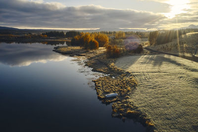 Lake and coast during sunset in autumn countryside