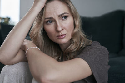 Depressed woman sitting at home