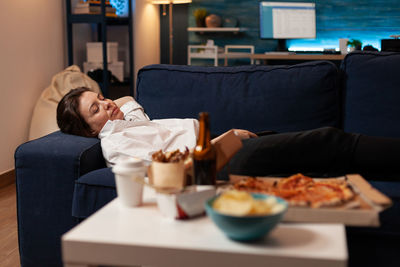 Portrait of woman sitting on sofa at home