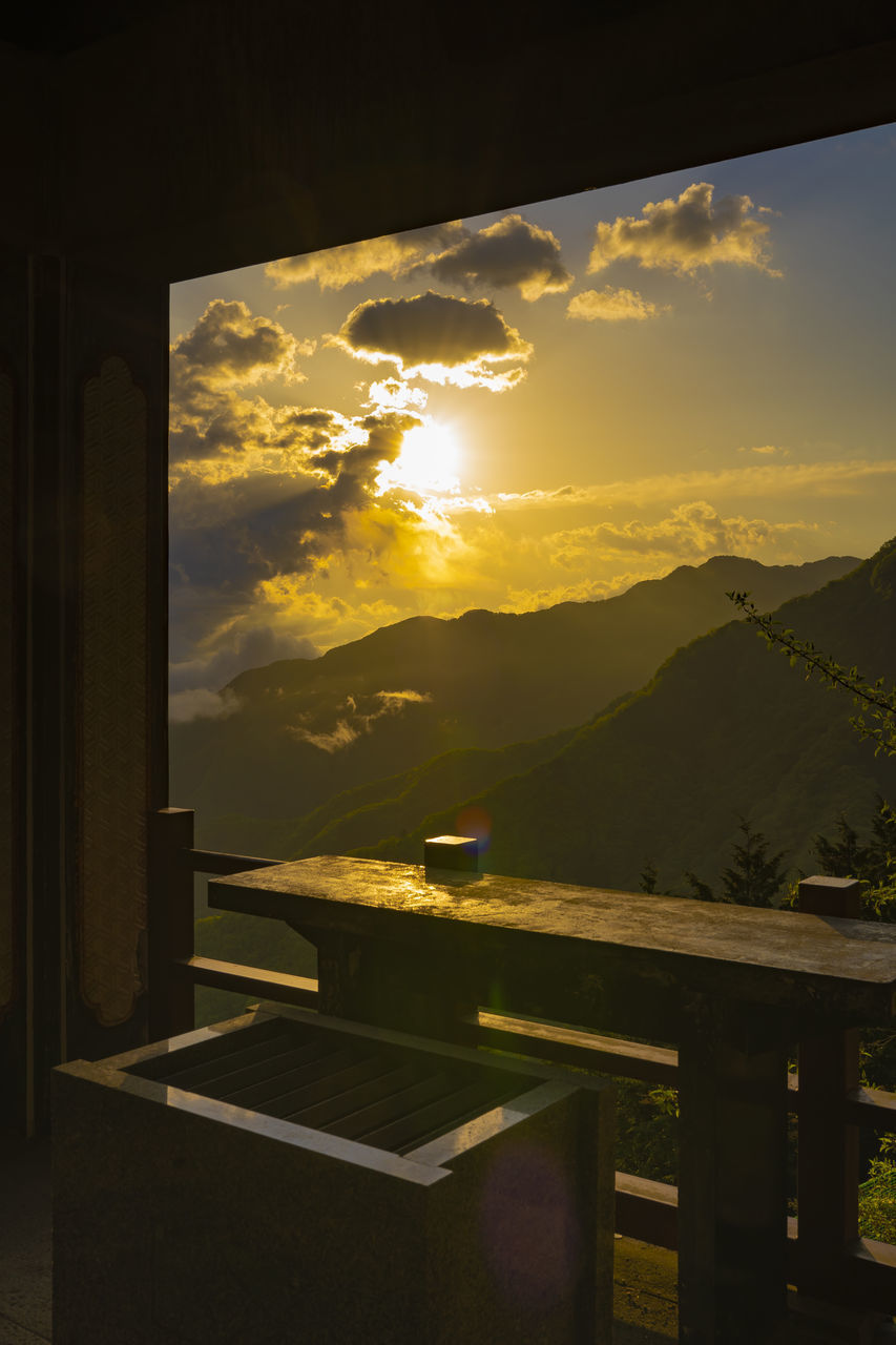 SCENIC VIEW OF SUNSET SEEN THROUGH WINDOW