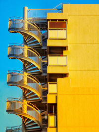 Low angle view of modern building against blue sky