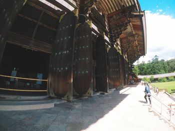 Rear view of man walking on building