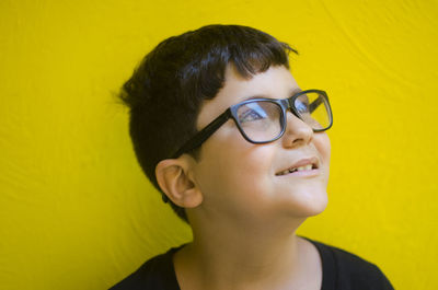 Close-up of boy against yellow background