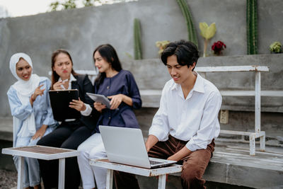 Side view of business colleagues working at office