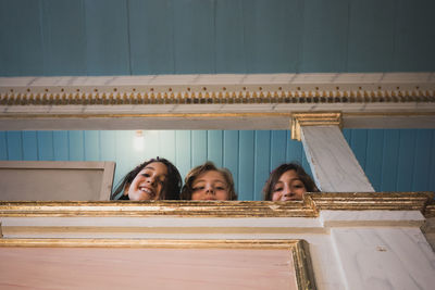 Low angle view of happy girls at home