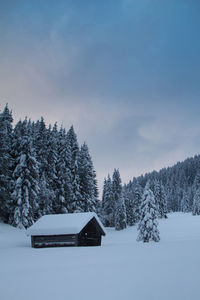 Snow covered mountain hut in the bavarian alps at geroldsee