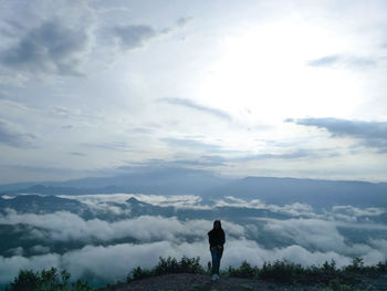 Woman standing on land against sky