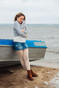 Young beautiful girl on the coast in winter