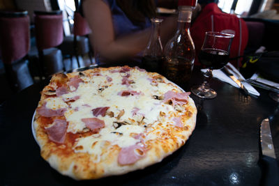 Close-up of pizza served on table in restaurant