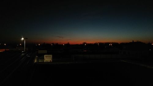 Illuminated city against sky at night