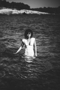 Portrait of woman wearing dress in sea