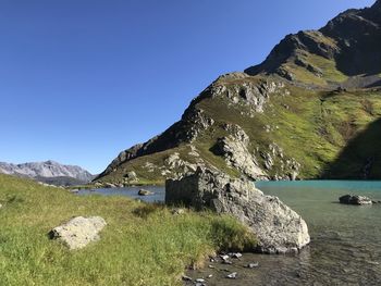 Scenic view of rocky mountains against clear blue sky