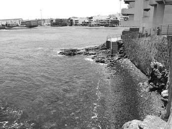 High angle view of river by buildings against sky