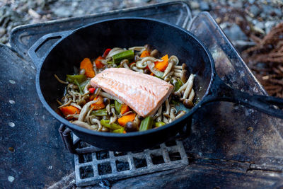 Close-up of food in cooking pan on barbecue grill