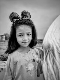 Portrait of cute smiling girl standing outdoors