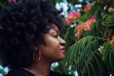 Close-up of young woman by tree