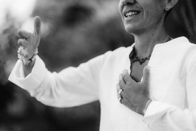 Spiritual coach sending positive thoughts hand gesture