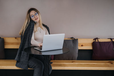 Young woman using laptop while sitting at home