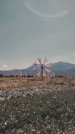 Traditional windmill on field against sky