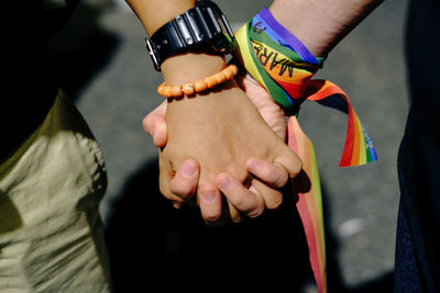 Midsection of couple holding hands