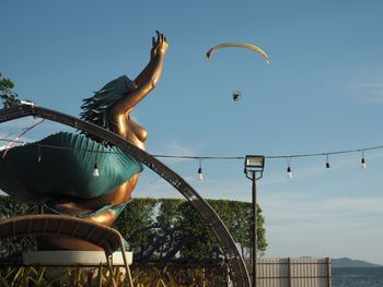 Low angle view of kite flying against sky