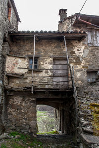 Low angle view of abandoned building against sky