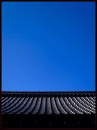 Low angle view of built structure against clear blue sky