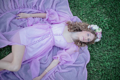 High angle portrait of girl lying on grass