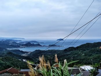 Scenic view of mountains against cloudy sky