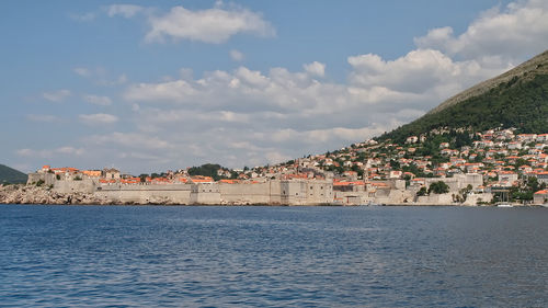 Town by sea against sky in city