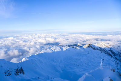 Scenic view of snowcapped mountains against blue sky