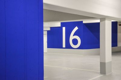 Number 16 on blue wall in underground garage