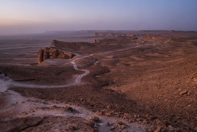 Scenic view of desert against sky during sunset