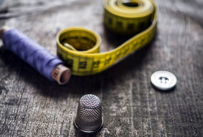 Close-up of various sewing items on wooden table