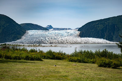 Scenic view of lake and mountains against sky