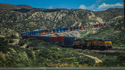 Train on railroad track against sky