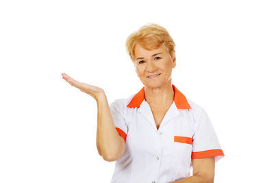 Portrait of smiling woman against white background